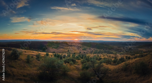 Soft autumn sunset panorama over countryside hills and valley. Beautiful rural landscape, nature scene. © psychoshadow