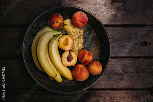 Overhead view of fruits bowl on wooden table