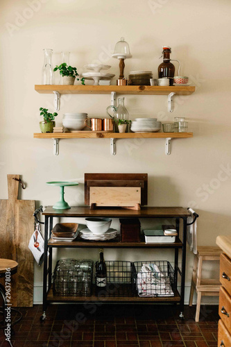 Kitchenware on wooden shelves and cart