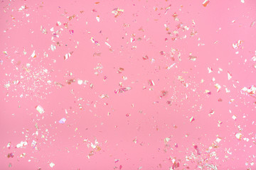 Pearl confetti on pink background.