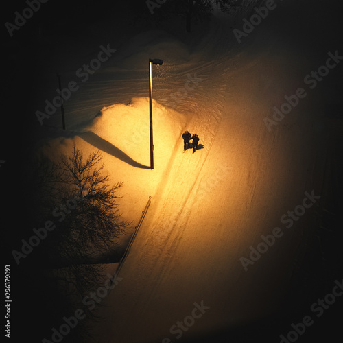 High angle view of couple walking on street at night