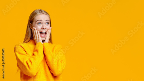 Shocked girl looking at copy space with amazement photo