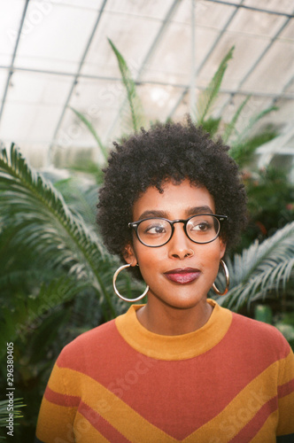 Portrait of young woman smiling in greenhouse
