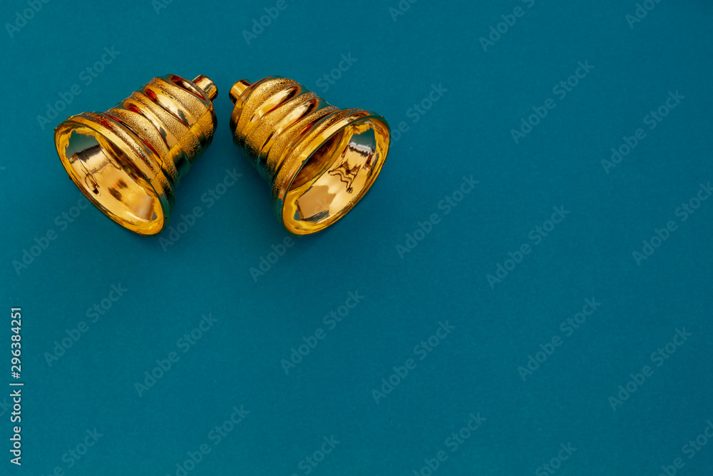 Composition Useful for Christmas and New Year Greeting Card With Two Gold Christmas Bell and Blue Background With Copy Space on The Right Side Composition Useful for Christmas and New Year Greeting Card With Two Gold Christmas Bell and Blue Background With Copy Space on The Right Side