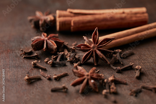 Star anise, cinnamon and dry spice cloves. Christmas spices on rustic wooden background. Close up. 