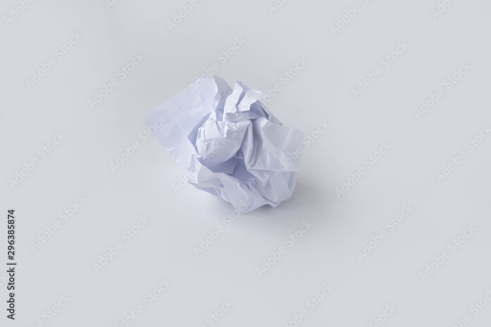 A clump of crumpled white paper on a white background.