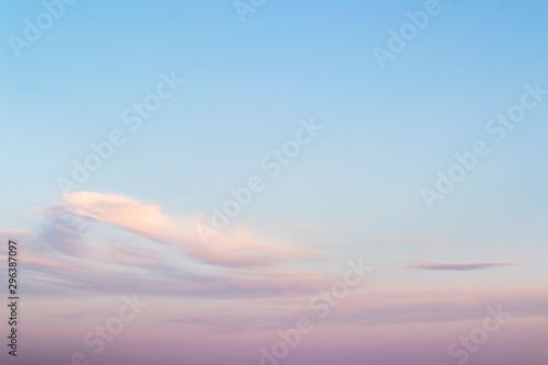 Sweet sky. Pink clouds in a blue sky at evening. Sky and clouds tranquil background with a pastel colors.