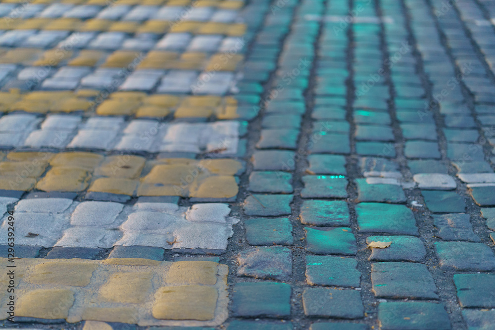 Naklejka premium Colorful pavement on the Moscow street. Pedestrian crosswalk in the sunset.