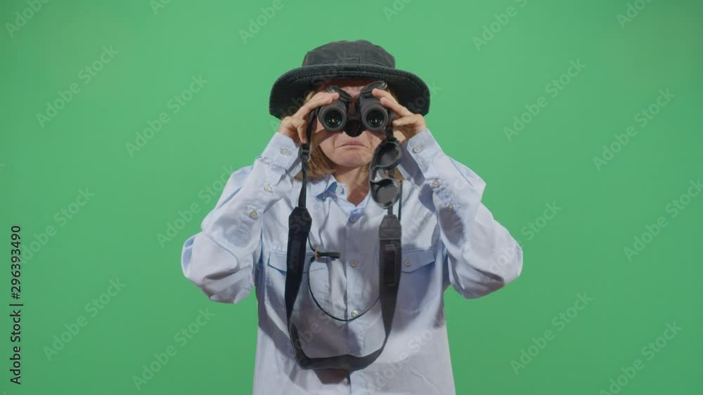 Frontal Shot Of Classical Woman Explorer Using Binoculars In The Wrong Way . Studio Isolated Shot Against Green Screen Background Frontal Shot Of Classical Woman Explorer Using Binoculars In The Wrong Way . Studio Isolated Shot Against Green Screen Background