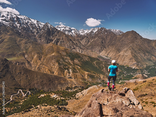 Blonde tourist grl above the Imlil valley in High Atlas mountains