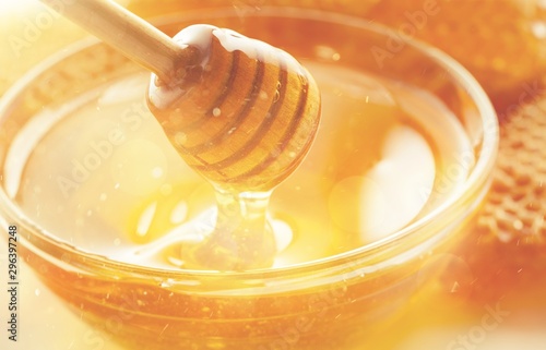 Honey with spoon in glass bowl