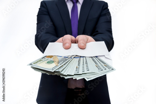 Businessman in suit holding envelope with dollar banknotes