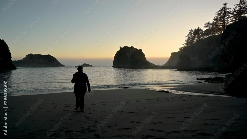 Slow motion walking shot with woman's silhouette near a beach Slow motion walking shot with woman's silhouette near a beach