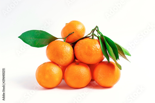 Tangerines or clementines with green leaf isolated on white background.