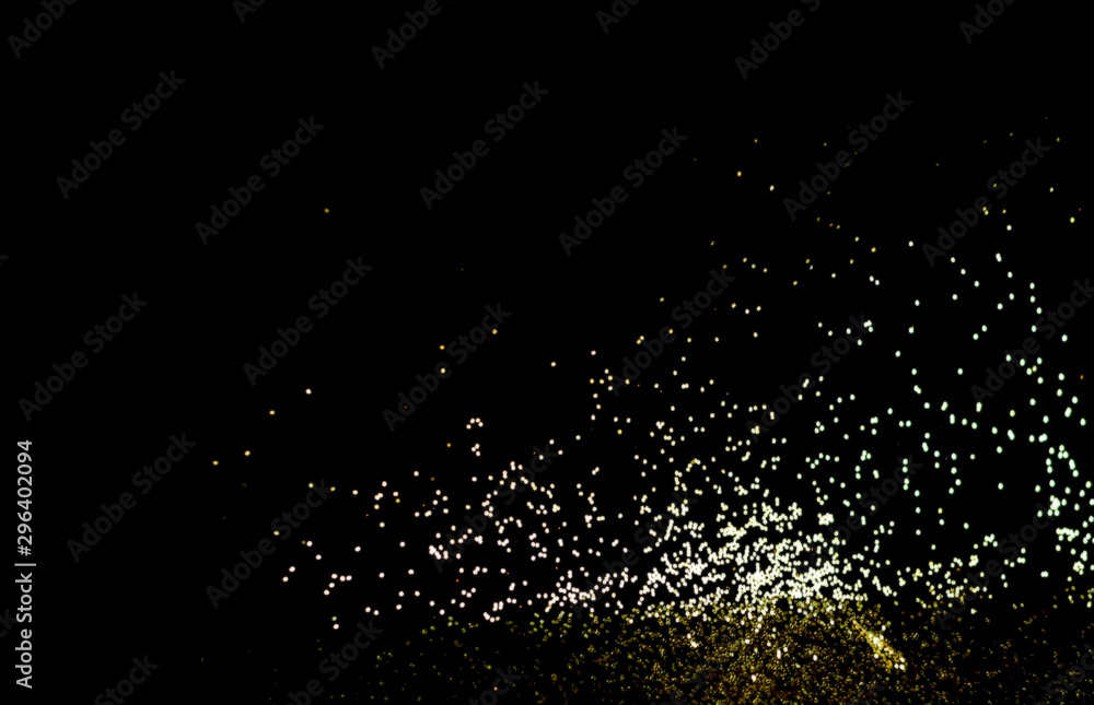 Black background with golden sparkles. Blurred  effect. Concept for festive background.Close-up,copy space