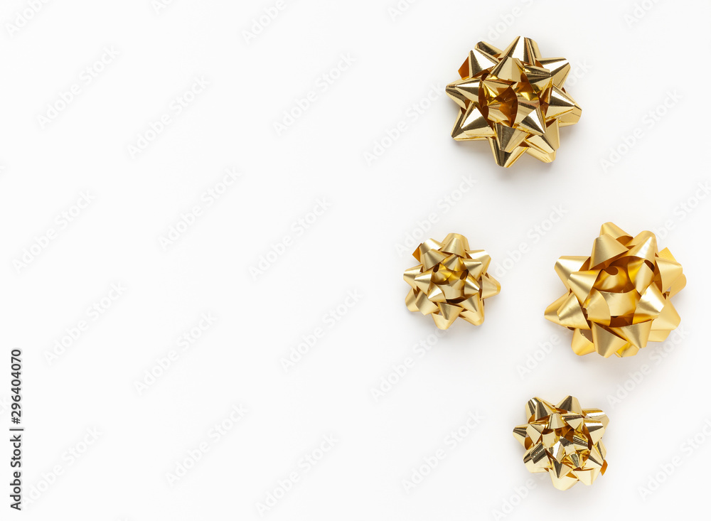 Christmas or New Year composition with gold sparkling ribbon decorations on white background. Flat lay, copy space. Christmas or New Year composition with gold sparkling ribbon decorations on white background. Flat lay, copy space.