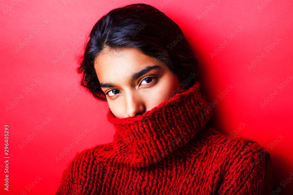 young pretty indian girl in red sweater posing emotional, fashion hipster teenage, lifestyle people concept young pretty indian girl in red sweater posing emotional, fashion hipster teenage, lifestyle people concept