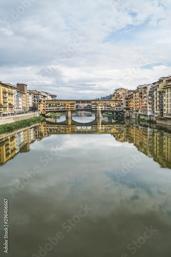 reflection of bridge and buildings on river in Florence, Italy