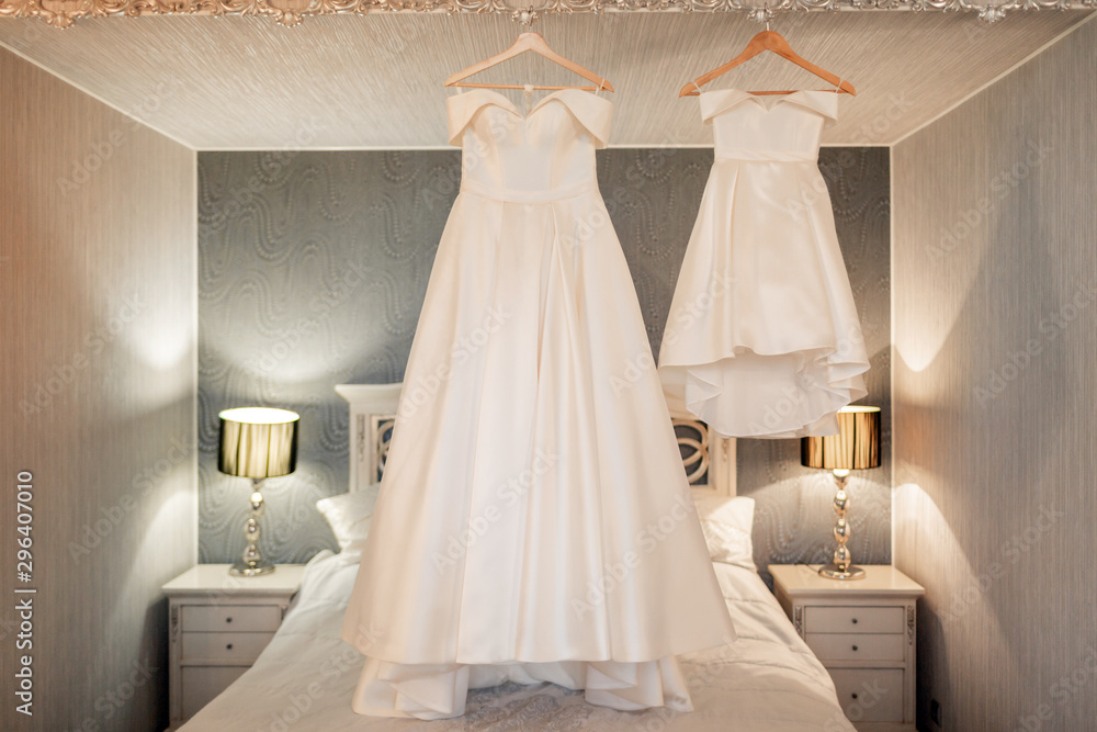 White wedding dress of the bride in the bedroom. White wedding dress of the bride in the bedroom.