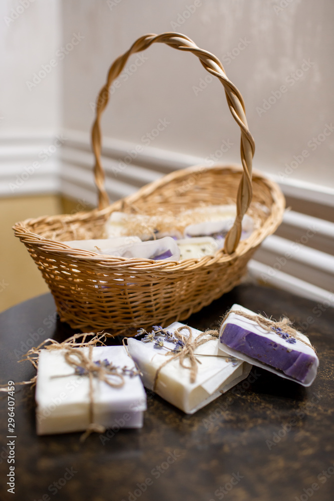 Lavender soap and salt in a wicker basket. A gift for guests.