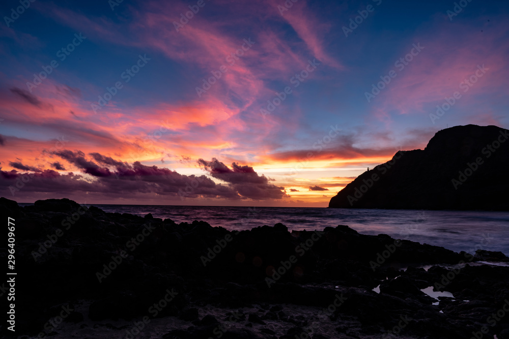 Makapuu lighthouse from Makapuu beach early dawn sunrise with a beacon of light reach out to vessels to safely navigate the straits 