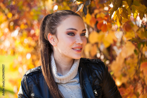 Portrait of a young beautiful model in a black leather jacket