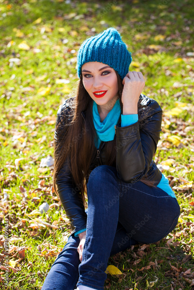 Happy woman in black leather jacket and blue knitted hat Happy woman in black leather jacket and blue knitted hat