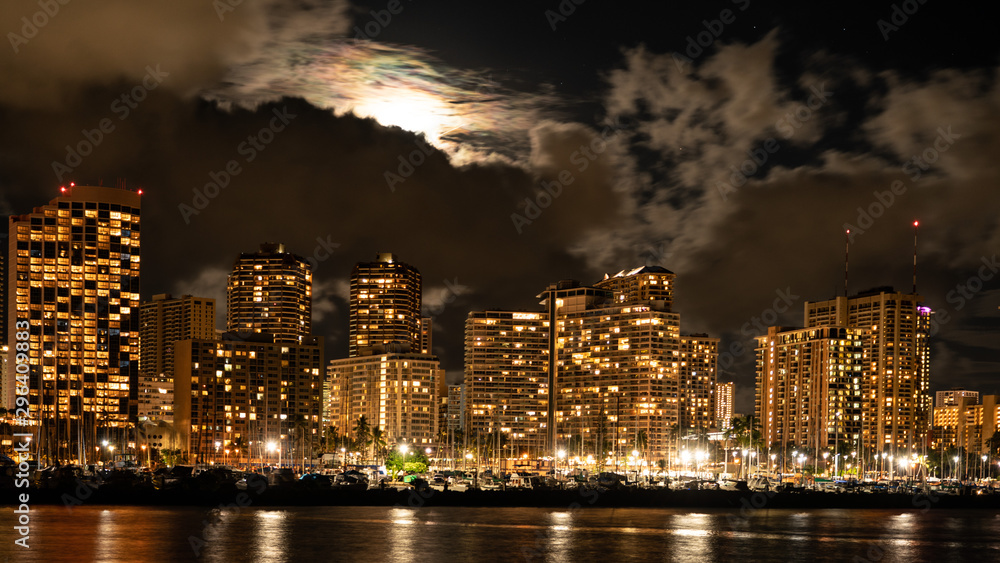 Honolulu night-scape with full moon above