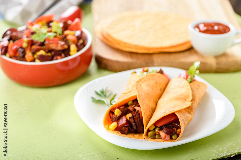 Tacos - delicious tortillas with meat and vegetables Tacos - delicious tortillas with meat and vegetables
