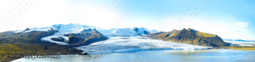 Icelandic landscape. Panorama of tourist visiting the Fjallsarlon glacier and the lagoon at sunset.