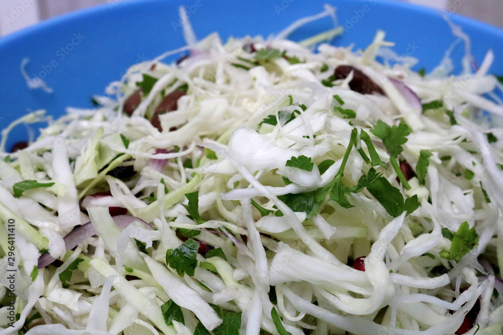 Fresh coleslaw salad. Salad from cabbage with onion, beans and pomegranate Selective focus Fresh coleslaw salad. Salad from cabbage with onion, beans and pomegranate Selective focus