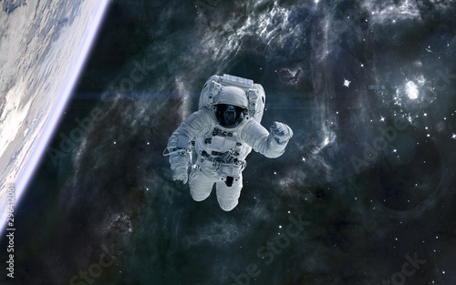 Fototapeta Naklejka Na Ścianę i Meble -  Astronaut in outer space. Supernova explosion. Planet, space landscape. Science fiction. Elements of this image furnished by NASA