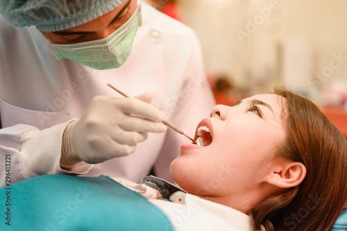 Dentist examining teeth patients in clinic for better dental health and a bright smile.