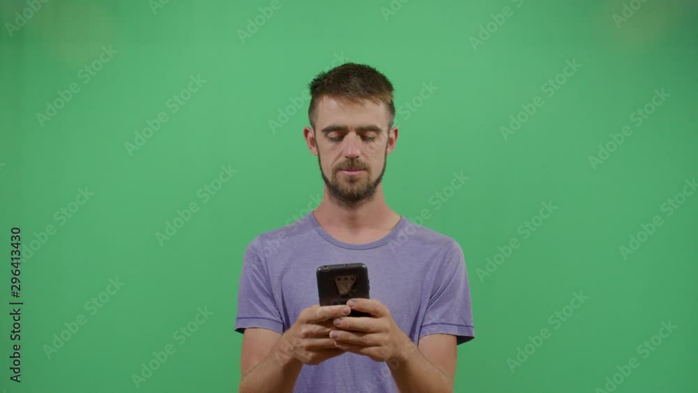 Adult Man Texting On A Mobile Phone With Great Hate. Studio Isolated Shot Against Green Screen Background Adult Man Texting On A Mobile Phone With Great Hate. Studio Isolated Shot Against Green Screen Background