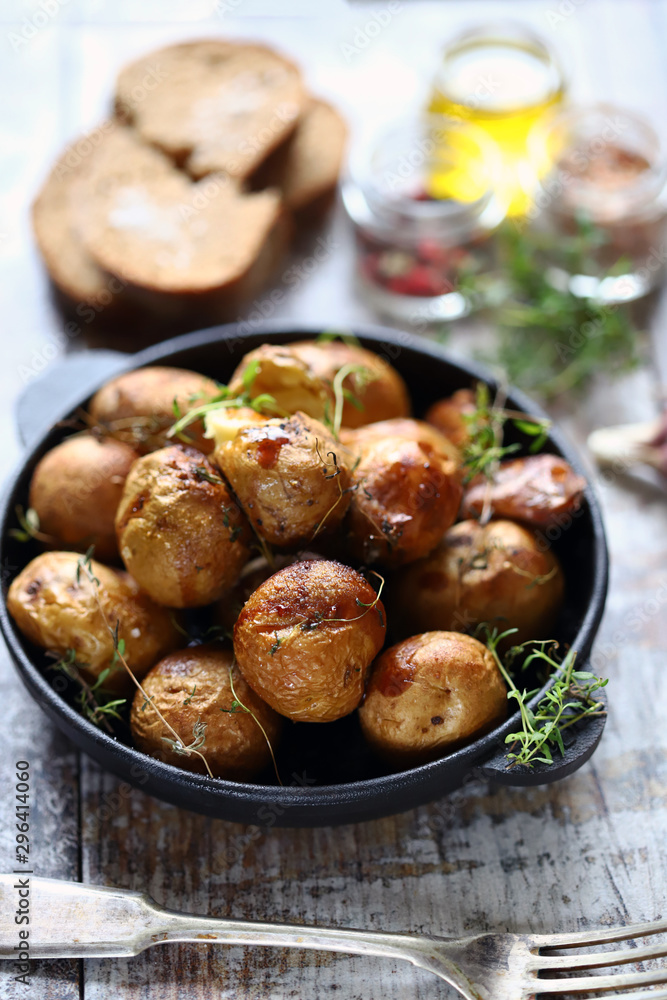 Rustic baked potatoes in a pan with herbs. Selective focus. Macro. Rustic baked potatoes in a pan with herbs. Selective focus. Macro.