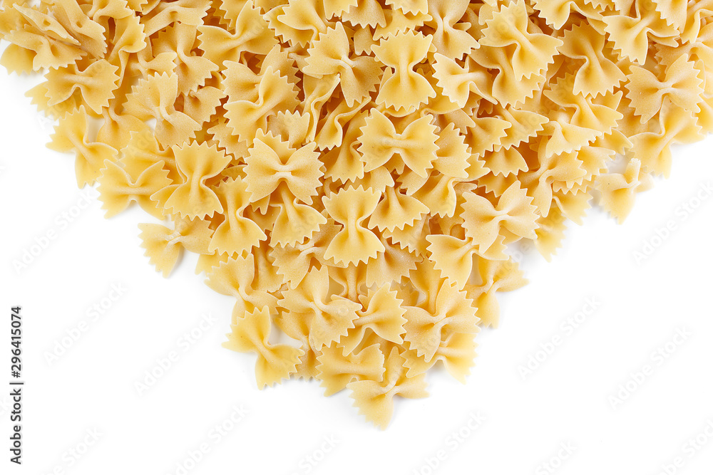 Obraz premium A variety of types and shapes of Italian pasta. Dry pasta bows farfalle . Heap of bow tie macaroni isolated on white background.
