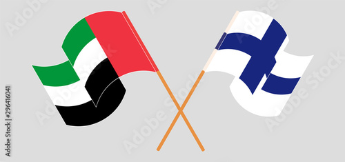 Crossed and waving flags of the United Arab Emirates and Finland