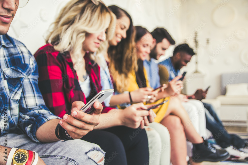 Close up of group of young people with smartphones in the hands. Young people addiction to new technology trends