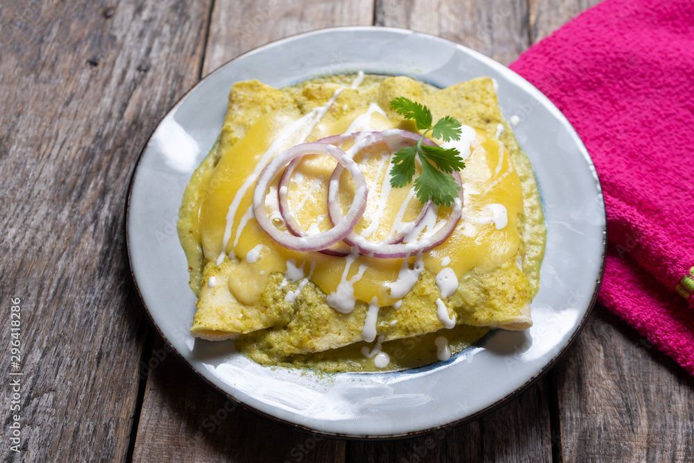 Mexican green enchiladas with melted cheese also called 