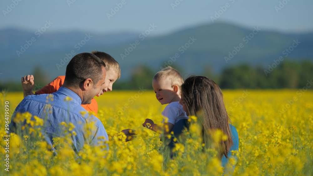 Smiling faces in rape field, brother love, portrait of happy family Smiling faces in rape field, brother love, portrait of happy family