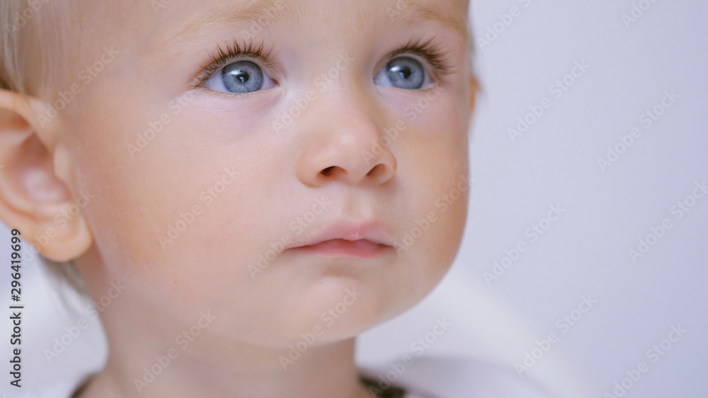 Innocent blue eyes look, close up blond hair baby portrait, purity