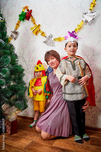Portrait of happy mother and two son in a room during Christmas or New Year © keleny