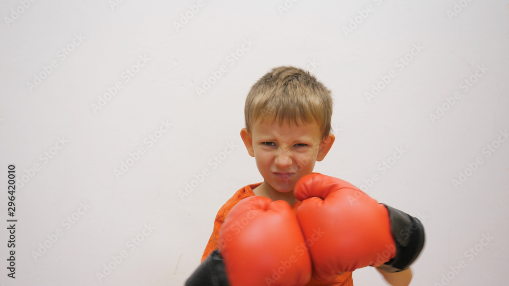 Single child with box gloves prepare to fight Single child with box gloves prepare to fight