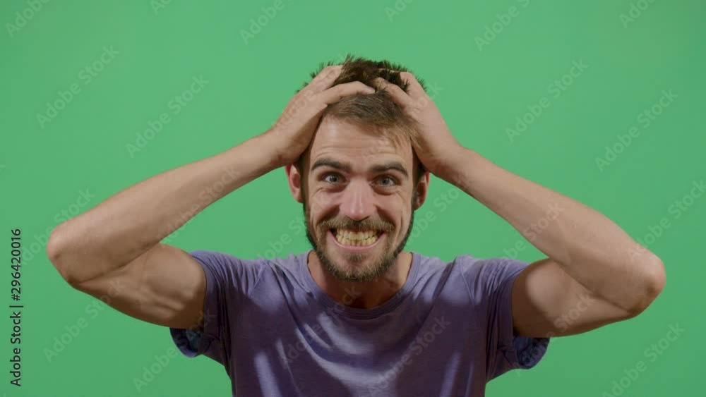 Adult Adult Man Pulling Her Hair In A Desperate Manner Like Something Extremely Bad Happened. Studio Isolated Shot Against Green Screen Background Adult Adult Man Pulling Her Hair In A Desperate Manner Like Something Extremely Bad Happened. Studio Isolated Shot Against Green Screen Background