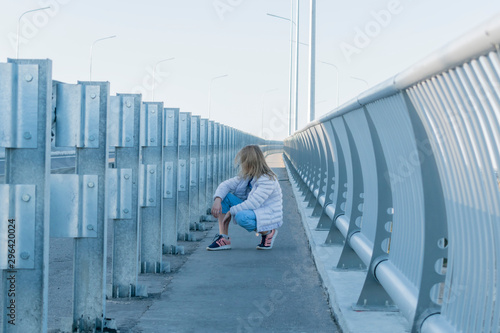 Little girl posing on the bridge