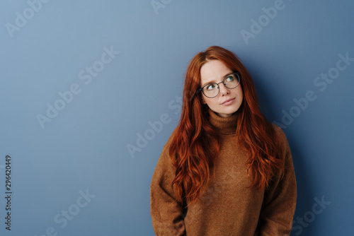 Thoughtful serious young woman wearing spectacles photo