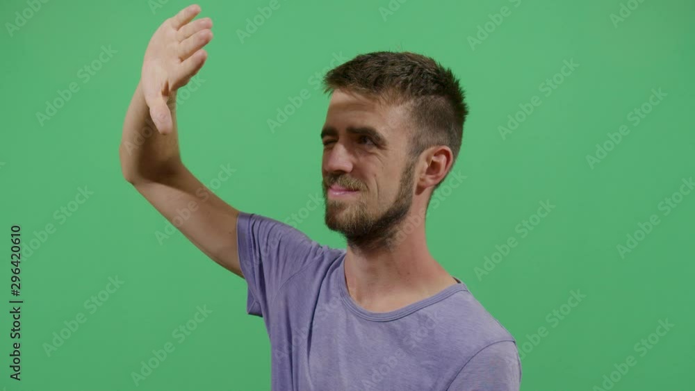 Adult Man Using The Hand As A Shade. Studio Isolated Shot Against Green Screen Background Adult Man Using The Hand As A Shade. Studio Isolated Shot Against Green Screen Background