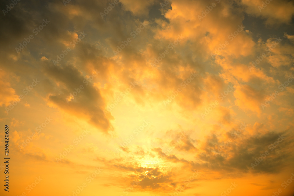 Golden sun light with dark cloud before sunset. - obrazy, fototapety, plakaty 