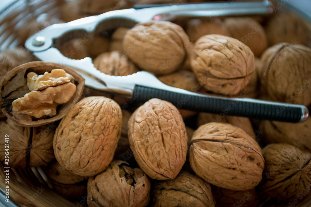 Nutcracker on brown walnuts. Whole walnuts Nutcracker on brown walnuts. Whole walnuts