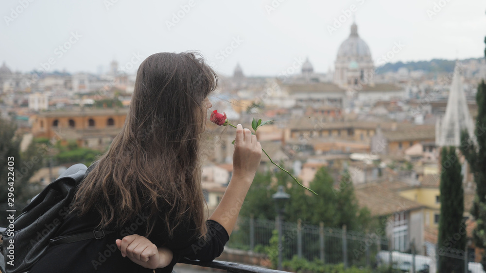Single woman with back enjoy flower France and admire Rome panorama, tourist